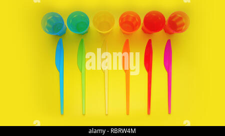 Colored plastic ware. Tableware for a picnic made of colored plastic. Knives and mug in the set of crockery for picnics, tourism and any travel. Yello Stock Photo