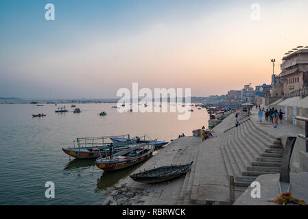 Boats at blue hour after sunset along the Ganges Ghat in Varanasi, India Stock Photo