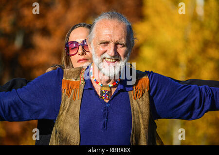 Portrait of good looking elderly man and woman enjoying life in a bright, sunny autumn day Stock Photo