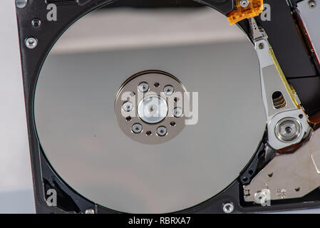 hard disk rotating details. open up computer memory device with reading head and disk Stock Photo