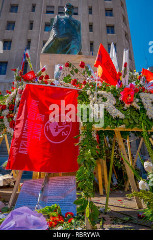 SANTIAGO, CHILE - SEPTEMBER 13, 2018: Outdoor view of bunch of flowers in front of the Monument to Salvador Allende Gossens in Santiago de Chile Stock Photo