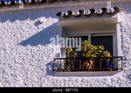 Window. Traditionally decorated Spanish windows with flower pots. Stock Photo