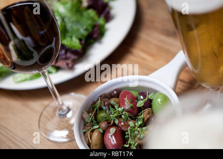 Close up of Italian Olives with Tyme served with meal and wine Stock Photo