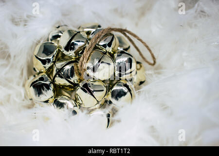 Christmas card. Golden Christmas ball on a background of white feathers. Stock Photo