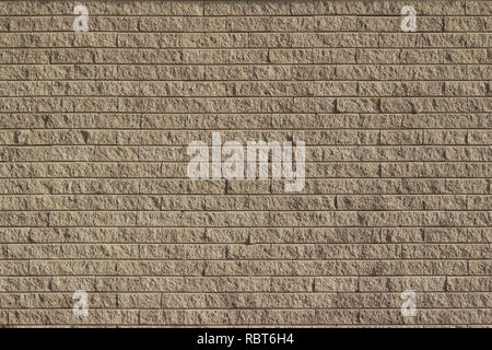 Light brown tan colored rough textured stone brick wall abstract background Stock Photo