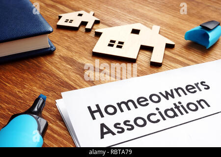 Documents about Homeowners Association HOA on a desk. Stock Photo