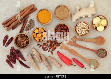 Fat busting spices for losing weight concept with turmeric, ginger, cumin, chilli, cinnamon and gymnema sylvestre used to suppress appetite. Stock Photo