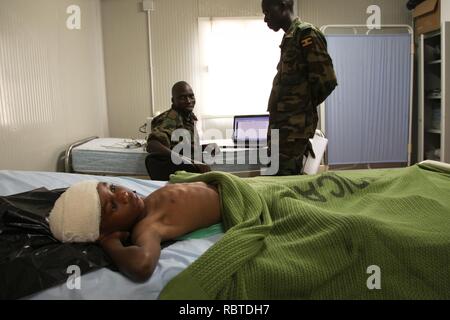 A young boy lies in the AMISOM Level II hospital on July 8 after having been wounded during fighting in Kismayo, Somalia. AU UN IST PHOTO - ILYAS A. ABUKAR (9239999156). Stock Photo