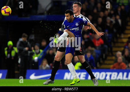 London, UK. 12th January, 2019. Pedro of Chelsea shoots and scores his teams 1st goal. Premier League match, Chelsea v Newcastle Utd at Stamford Bridge in London on Saturday 12th January 2019.  this image may only be used for Editorial purposes. Editorial use only, license required for commercial use. No use in betting, games or a single club/league/player publications. pic by Steffan Bowen/ Andrew Orchard sports photography/Alamy Live news Stock Photo