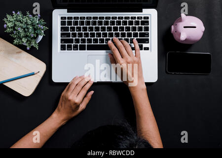 Woman hands typing on keyboard in office desk, Top view Stock Photo