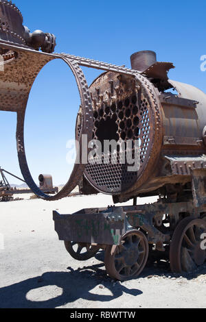 Abandoned yet sculptural, the remains of old steam trains lie rusting in the desert outside Uyuni, Bolivia at the Train Cemetary. Stock Photo