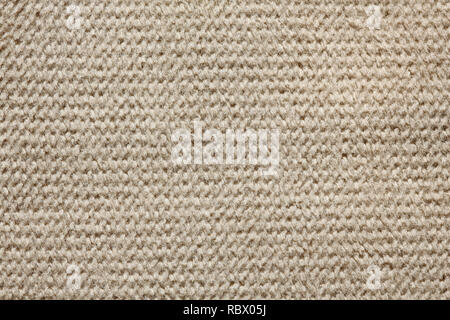 Knitted light brown textile background on macro. Stock Photo