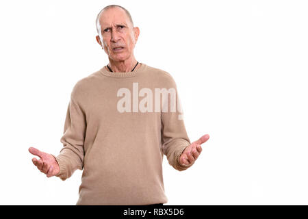 Studio shot of angry senior man looking confused Stock Photo