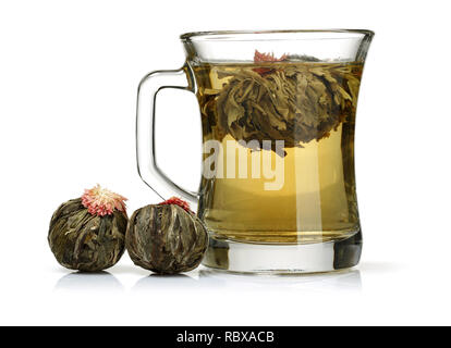 Jasmine tea in glass mug with Jasmine balls isolated on white background Stock Photo