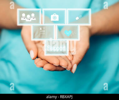Concept of medical support and care. doctor holding virtual blocks with medical icons. Stock Photo
