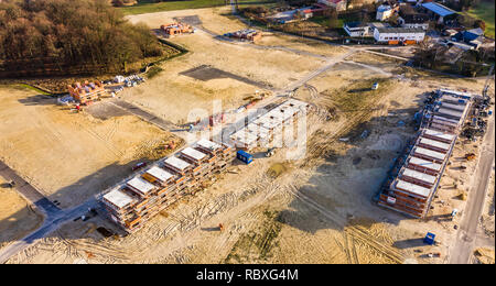 Wolfsburg, Germany, January 3., 2019: Aerial view of the shell of a large terraced house in a new development area next to an old village centre Stock Photo