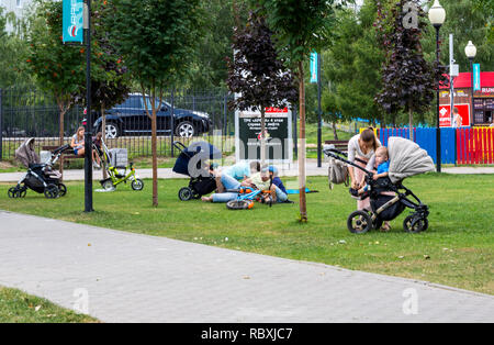 Voronezh, Russia - August 12, 2018: Young parents walk with children in the park 'Arena', the city of Voronezh Stock Photo