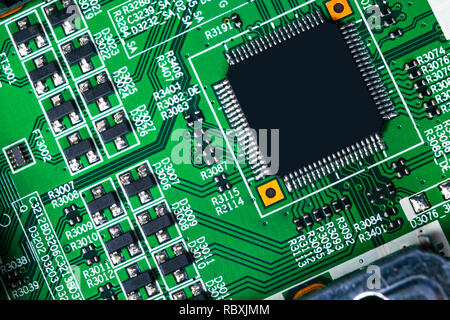 Macro shot of a Circuitboard with resistors microchips and electronic components. Computer hardware technology. Integrated communication processor. In Stock Photo