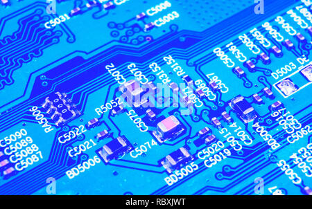 Macro shot of a Circuitboard with resistors microchips and electronic components. Computer hardware technology. Integrated communication processor in  Stock Photo