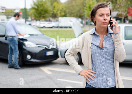 Woman driver and angry man arguing about the damage of the ...