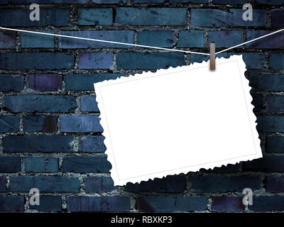 Blank postcard frame against blue painted brick wall background Stock Photo