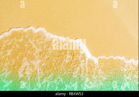Golden sand at seaside. Sea water wave on the beach. Sand and sea water texture background.Summer vacation on tropical paradise beach concept. Ripple  Stock Photo