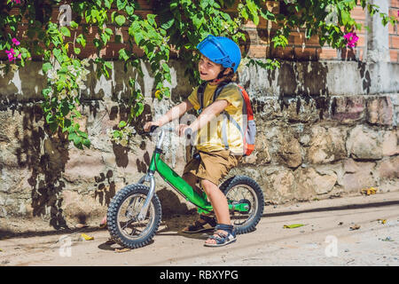 Little boy on a bicycle. Caught in motion, on a driveway motion blurred. Preschool child's first day on the bike. The joy of movement. Little athlete  Stock Photo