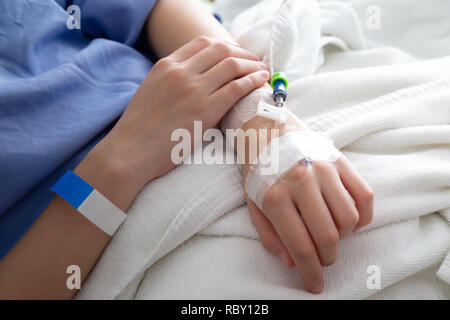 female patient sleeping on the patient bed in the room after surgery at the hospital. Stock Photo