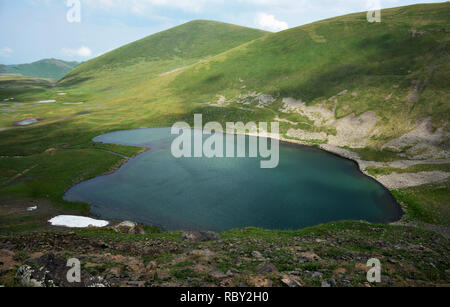 Mountain lake as heart. Heart shaped lake. Beautiful  heart shaped lake at the mountains. When nature is romantic. Amazing place in the Beauty World. Stock Photo