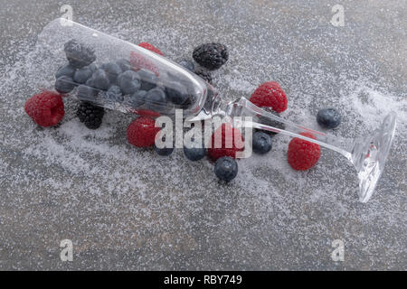 Fresh berries and chanpagne glass on a plate of granite whith sugar .  - Imagen