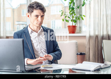 The official businessman sitting at workplace in office refuses bribes. The concept of corruption and bribery Stock Photo