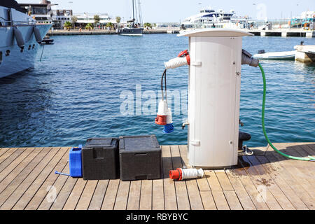 Shore Based Electricity Supply Appliance Power Supply And Battery Charged on the dock . Stock Photo