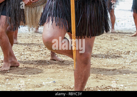 Maori warrior standing on one leg at  a Haka (warrior dance) in New Zealand Stock Photo