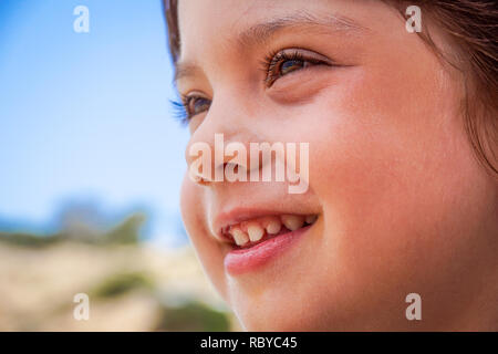 Portrait of adorable smiling little girl child outdoors in summer day Stock Photo