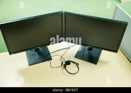 City Riga, Latvia. Interior, desktop computer to table, black monitors. Travel photo 2019, january. Stock Photo