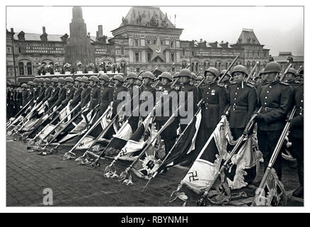VICTORY PARADE MOSCOW Vintage Post WW2 image of The Victory Parade on Red Square in Moscow. Soviet Red Army soldiers with defeated fighting banners of the Nazi troops. This Victory Parade ended in the formation of Soviet troops carrying captured 200 combat banners of the defeated Nazi Army. These banners under playing of drums were thrown on a special platform near the foot of Lenin’s Mausoleum. The flag of the SS division “Leibstandarte SS Adolf Hitler” was thrown first. Red Square Moscow, USSR Date: June 1945 Stock Photo
