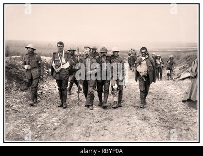 WW1 Battle of The Somme archive image of  a German prisoner helping British wounded make their way to a dressing station near Bernafay Wood following fighting on Bazentin Ridge, 19 July 1916, during the Battle of the Somme. Five British and German walking wounded, injured on the way to a dressing station near Bernafay France Stock Photo
