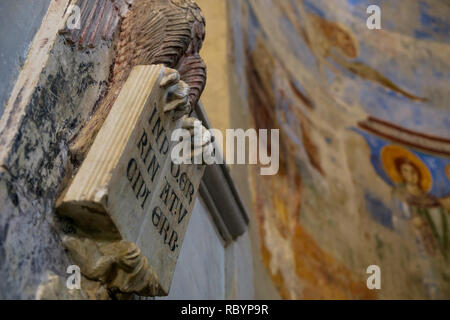 The basilica of 'Sant'Angelo in Formis' is of particular historical value and on behalf of frescos, has sculptures like this one of an open bible. Stock Photo