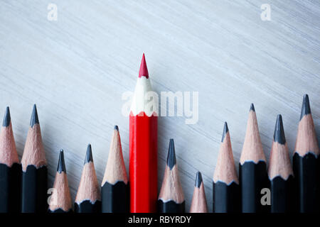 Red pencil standing out from crowd of Stock Photo