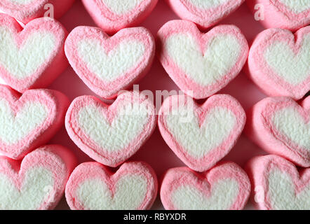 Top View of Lined Up Pastel Pink and White Heart Shaped Marshmallow Candies for Background, Banner, Pattern Stock Photo