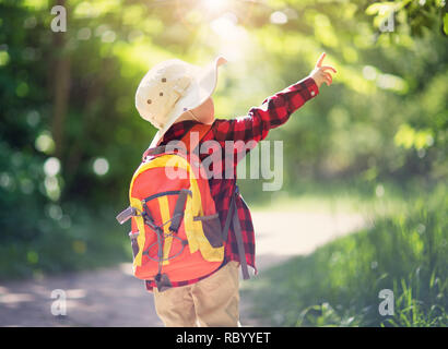 boy going camping with backpack in nature Stock Photo