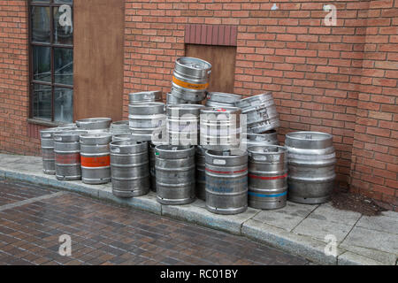 Stack or beer kegs on pavement, UK Stock Photo