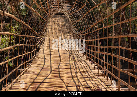 Wooden with bamboo bridge for cross over stream river from Tad Pha Suam waterfalls in Pakse, Champasak, Laos Stock Photo