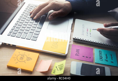 Young business working with planning project  on table.Using laptop and note papter.Analyze concepts ideas Stock Photo