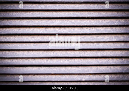 horizontal stripes of dusty metal jalousie exterior with vignette. background, texture. Stock Photo