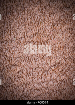 beige fabric terry cloth towel texture with vignette. background, bedroom. Stock Photo