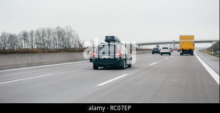 FRANKFURT, GERMANY - FEB 18, 2018: Driver POV personal perspective toward the driving Volvo V70 D4 and other cars on the autobahn highway  Stock Photo