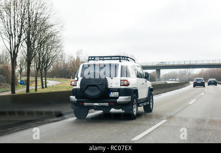 FRANKFURT, GERMANY - FEB 18, 2018: Driver POV personal perspective toward the driving Toyota FJ cruiser SUV car on the autobahn highway  Stock Photo