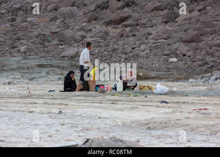 A family sitting on the beach of Urmia Lake, West Azerbaijan province, Iran Stock Photo