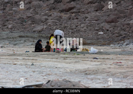 A family sitting on the beach of Urmia Lake, West Azerbaijan province, Iran Stock Photo